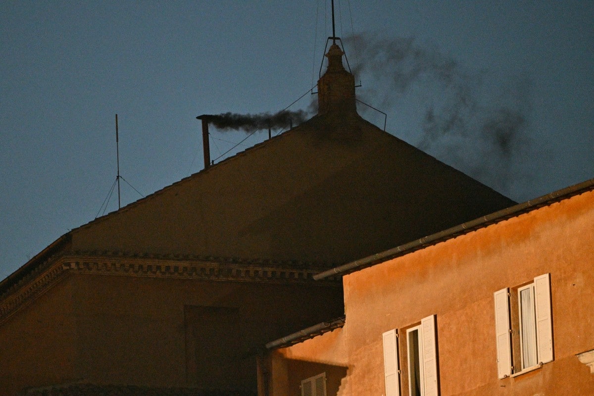 This photograph shows black smoke rising from the chimney of the Sistine Chapel signalling that cardinals failed to elect a new pope in the first ballot of their conclave in the Vatican on May 7, 2025. (Photo by Andreas SOLARO / AFP)