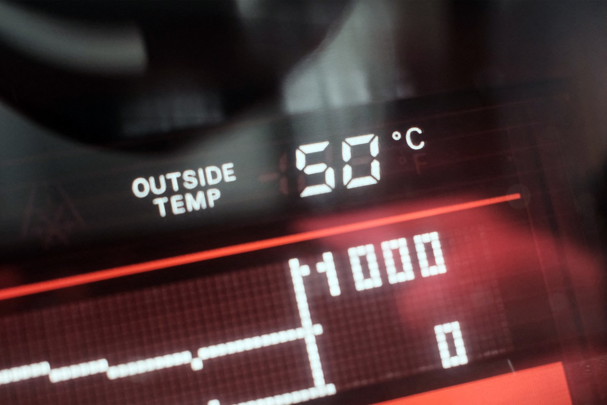 A dashboard display shows an external temperatue of 50 degrees celsius outside a vehicle in Dubai on May 23, 2025. (Photo by Giuseppe CACACE / AFP)